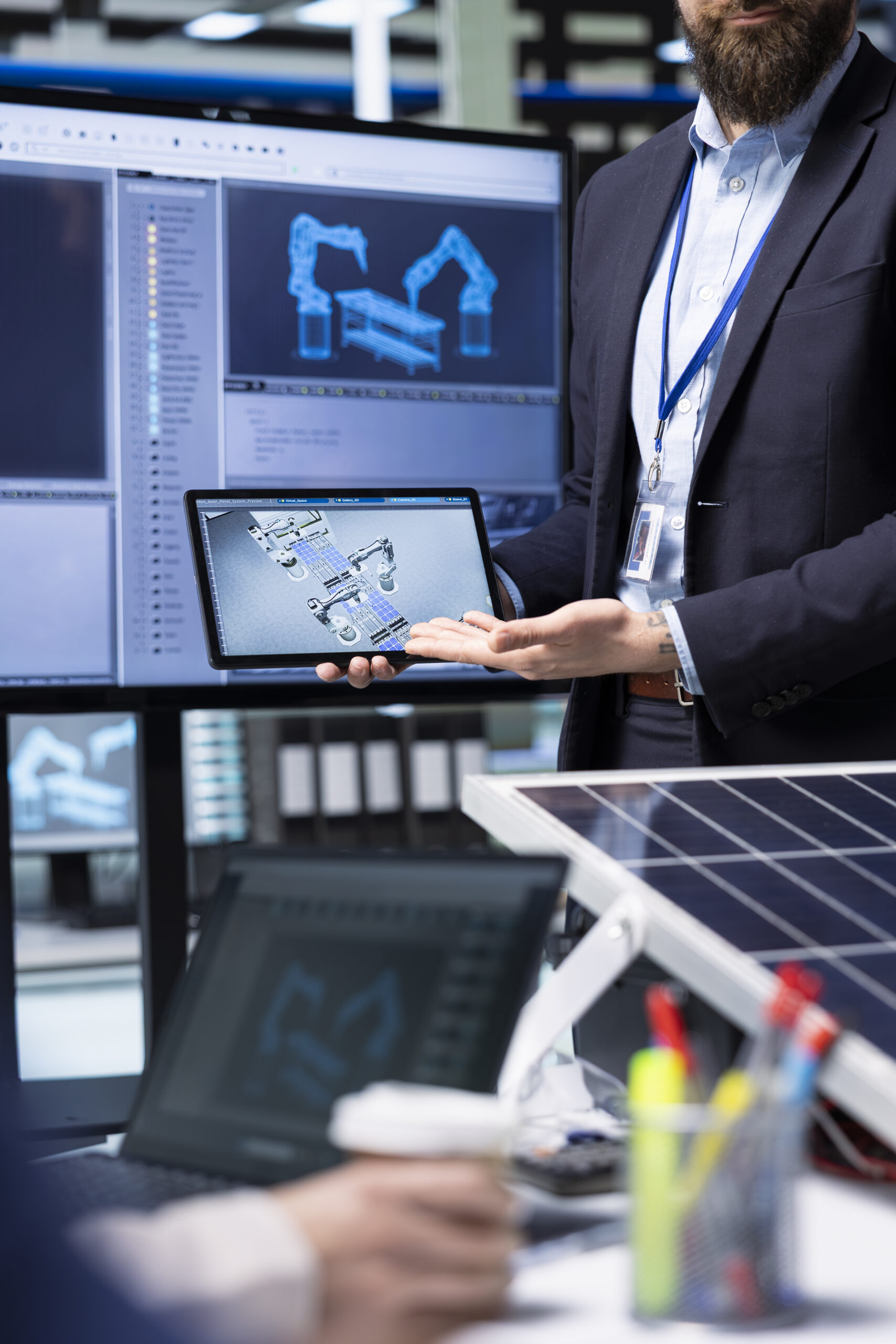 Shareholders planning factory upgrades using CAD software on devices