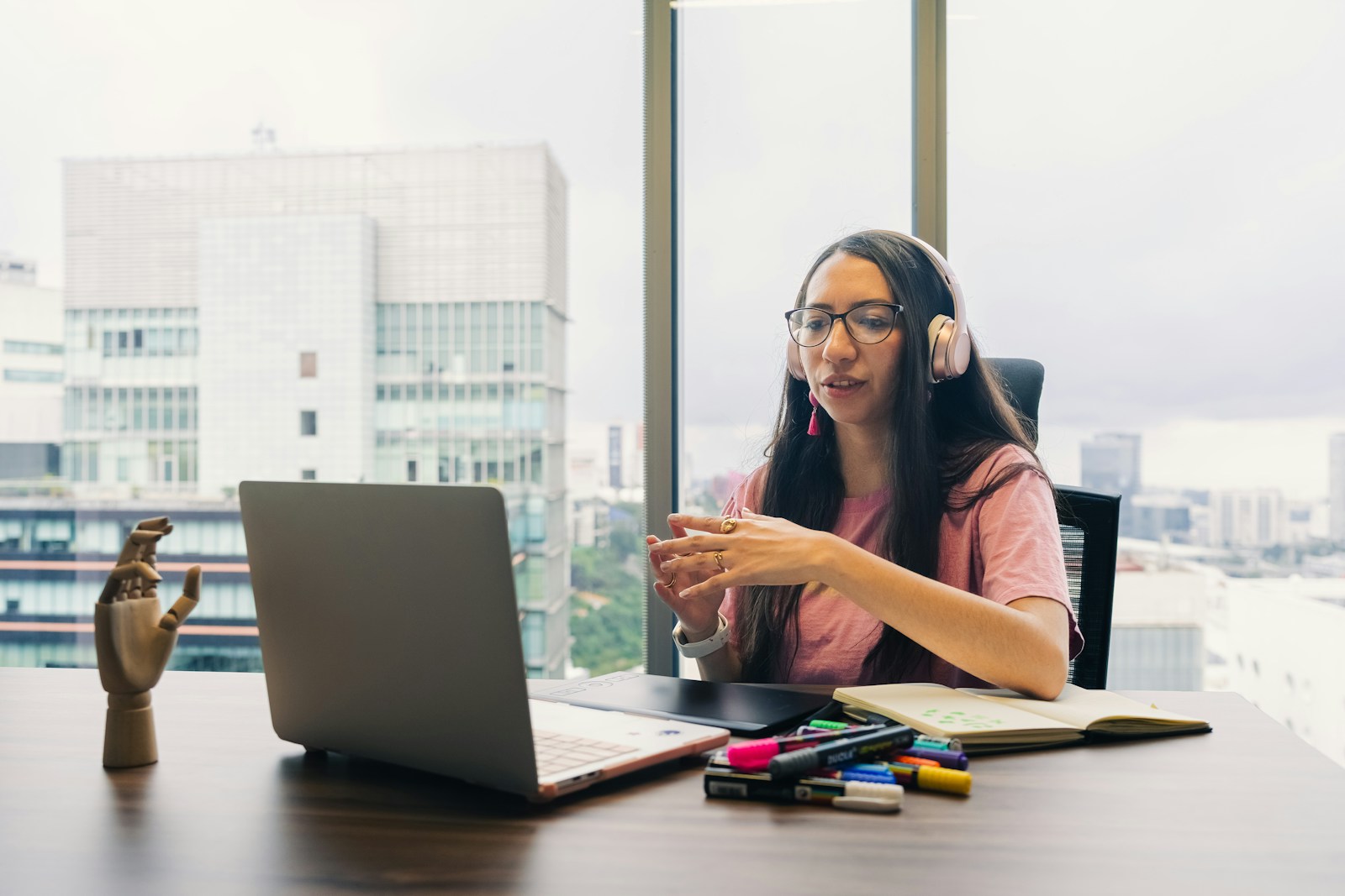 Professional wearing headphones on a video call at a laptop